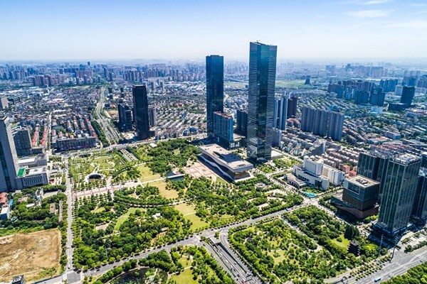 assist services land acquisition p3 Urban city layout with tall buildings and green spaces, highlighting project-based land allotment for corporate real estate